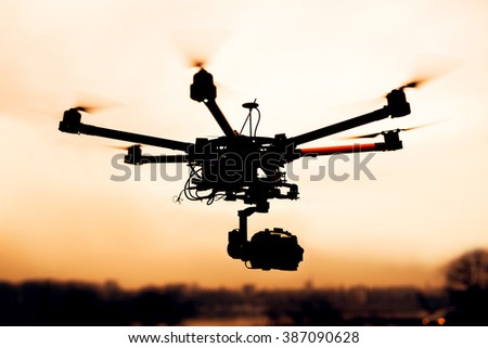 Drone. Silhouette against the sunset sky.