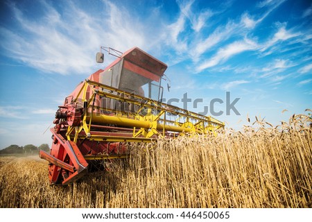 Close up of a harvester cropping the field.