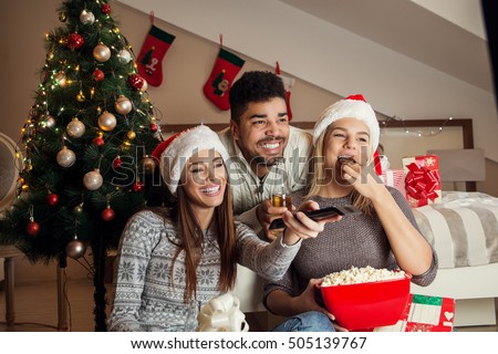 Friends watching movie and having fun at Christmas eve.