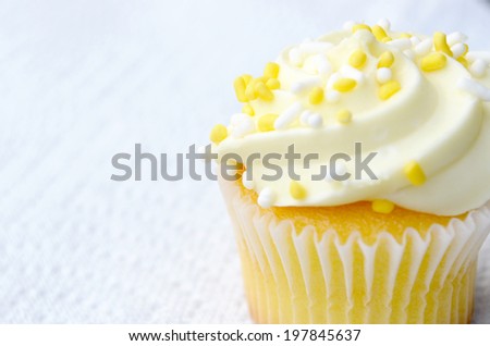 Homemade yellow mini cupcake with sprinkles