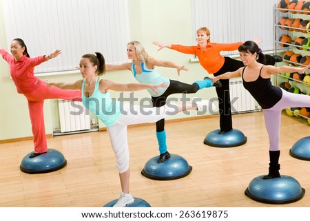 Health Club: Women of Different Age (from 18 to 50) Doing Step Aerobics in the Gym