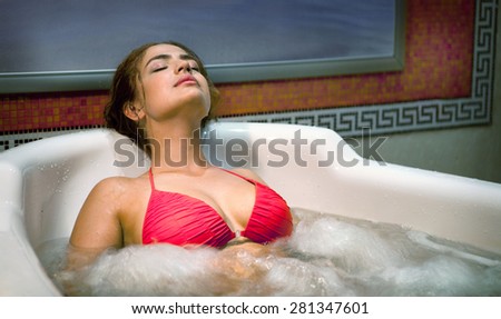 Healthy Spa: Young Beautiful Relaxing Woman Lying in the Bath with Hydro Massage
