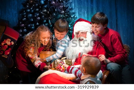 King Santa Clause giving Christmas Presents to Happy Children in the Christmas Night