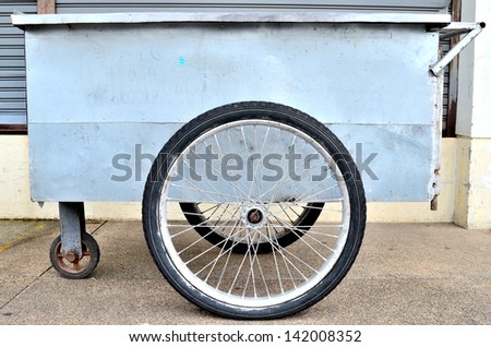 A stainless steel trolley with a big wheel