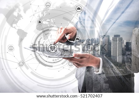 double exposure of business person holding tablet PC and modern cityscape, worldwide marketing information concept