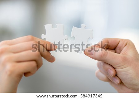 man and woman hand holding jigsaw puzzles, business matching concept