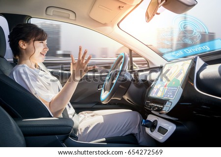 young woman riding autonomous car. self driving vehicle. autopilot. automotive technology.
