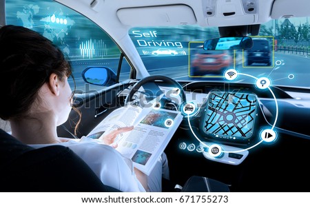 young woman reading a book in a autonomous car. driverless car. self driving vehicle. heads up display. automotive technology.