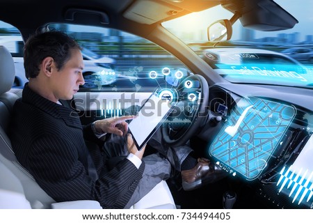 Caucasian man riding autonomous car. Self driving vehicle. Driverless car.