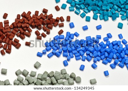 four different dyed plastic granulates for injection moulding industry