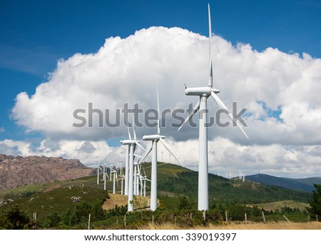 windmill-powered plant on hilltop in Europe