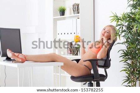 the beautiful young woman at office in bikini dreams