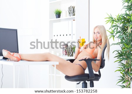 the beautiful young woman at office in bikini dreams