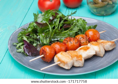 barbeque chicken with tomatoes in a plate with salad