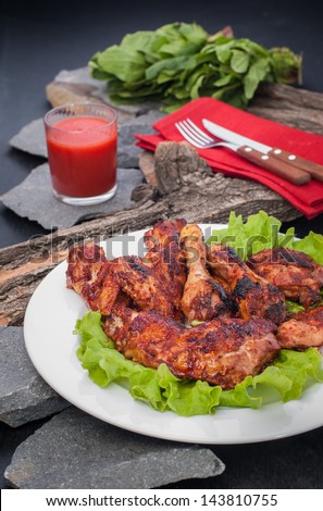 Chicken on grill with hot bbq sauce
