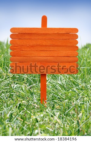 Wood sign on a lawn.