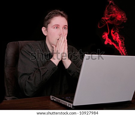 surprised unhappy man sees computer smoking