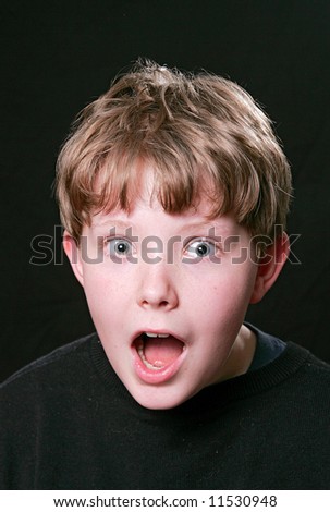 shocked guy with wide eyes and open mouth close up facial expression over black