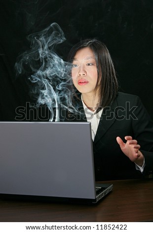 young attractive asian woman working on a laptop computer