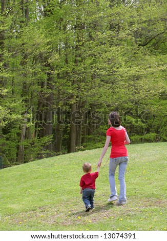 mom and child going for a walk to go fishing with poles in hand