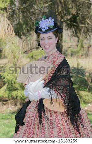 outdoor portrait of an attractive young girl in a Civil War era 1860s dress