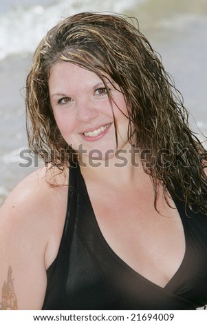 one attractive plus size model posing at the beach