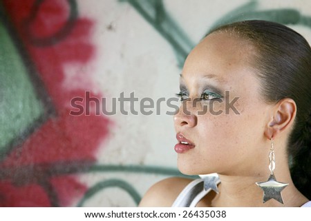 pretty African American woman portrait outdoors with graffiti background
