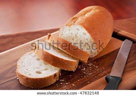 loaf of thick slice Italian bread on a cutting board. closeup horizontal format.