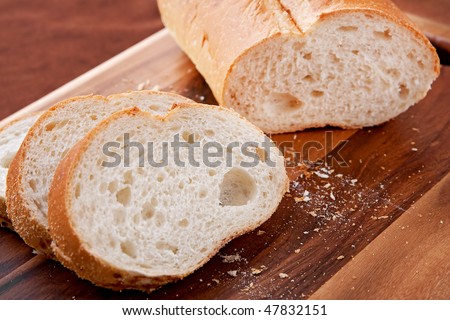loaf of thick slice Italian bread on a cutting board. closeup horizontal format.
