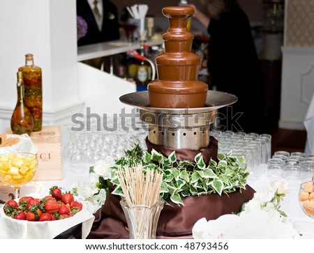 tall 4 level chocolate fountain and various dunking items at a wedding