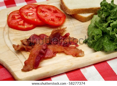 bacon, lettuce and tomato ingredients on a wooden cutting board