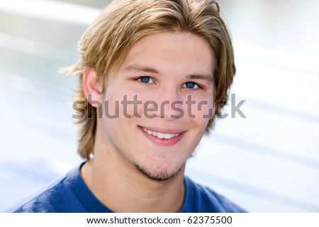closeup portrait of a dirty blonde haired guy outdoors