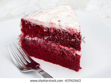 one slice of red velvet cake on a white plate with a fork