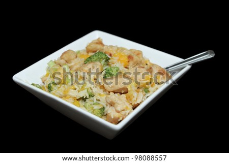 close up bowl of ginger orange chicken with broccoli and soy sauce