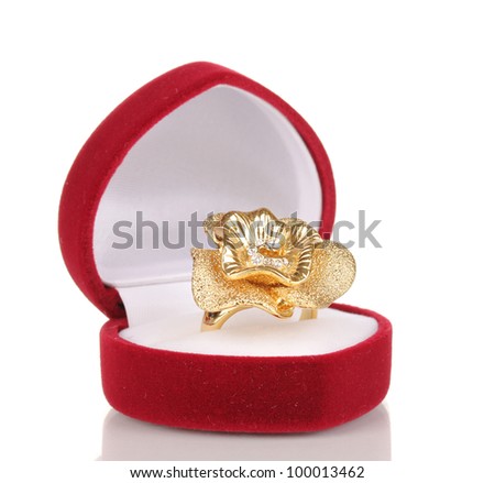 Gold ring with golden flower and clear crystals in red velvet box isolated on white
