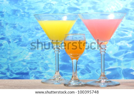 exotic cocktails on table on blue sea background