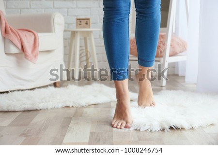 Woman walking on fluffy carpet at home