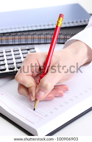 women hands with pencil, notebooks and Calculator close up