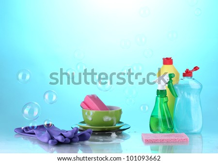 Washing dishes. Cleaning products  on bright blue background
