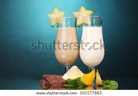 Milk shakes with fruits and chocolate on blue background