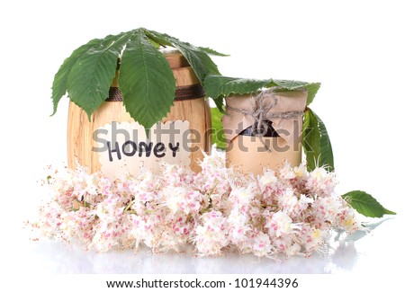 a barrel and a jar of honey and chestnut flowers isolated on white background