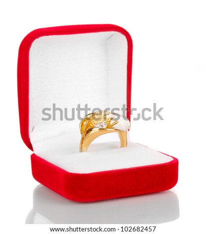 Gold ring with silver pattern and clear crystals in red velvet box isolated on white