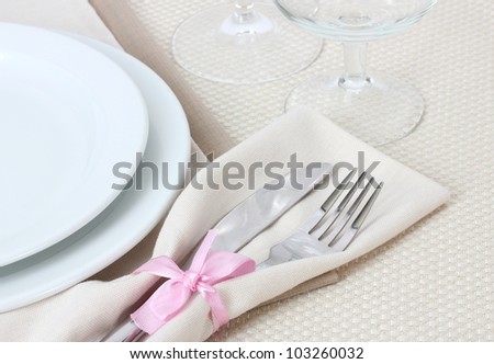 Table setting with fork, knife, plates, and napkin
