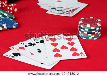 The red poker table with playing cards. The combination of straight