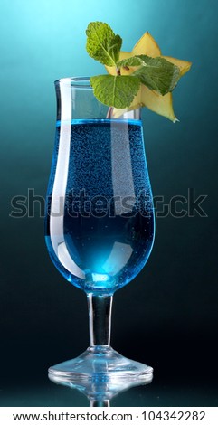 Blue cocktail in glass on blue background