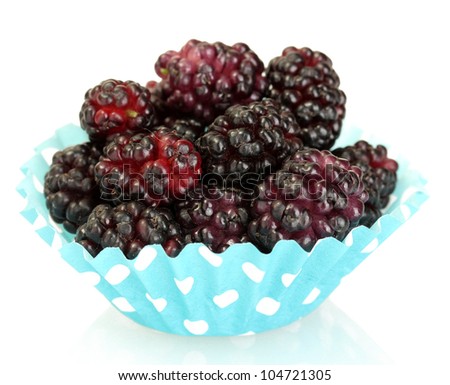 Ripe mulberries in cup cake paper isolated on white close-up