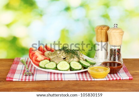 Delicious cooked dumplings with vegetables in the dish on bright green background