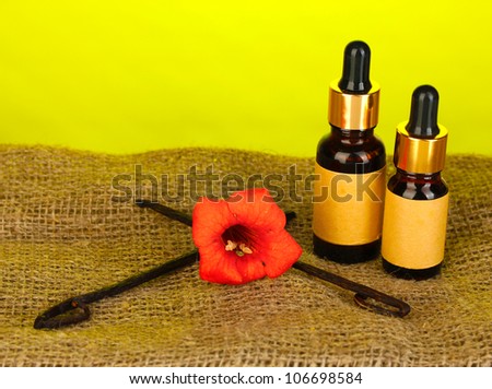 Vanilla pods with essential oil on colorful background