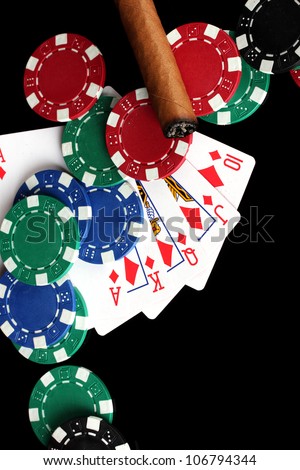 frame made of playing cards and poker chips on black background close-up
