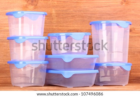 Plastic containers for food on wooden background